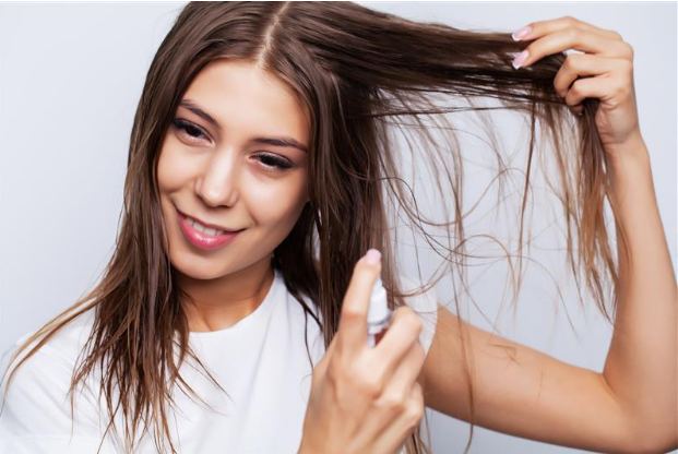 How to Restore Damaged Hair Fast: Causes & Preventive Tips Young woman applies conditioner to restore damaged hair